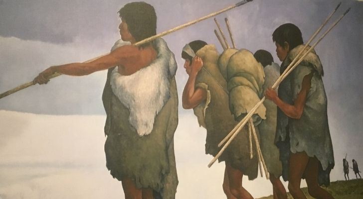 Three Paleo-Indians walking