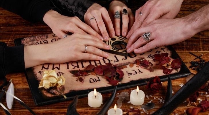 People playing a Ouija board