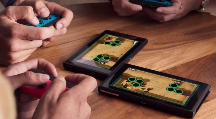 People playing the Switch on different screens connected together