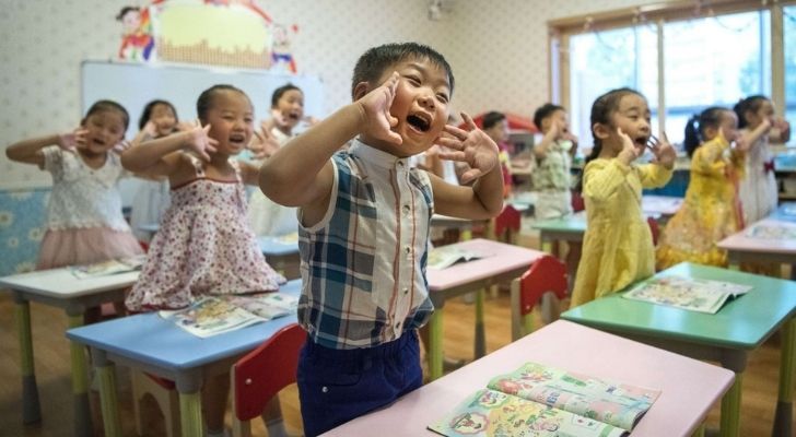 Children in North Korea at school looking happy