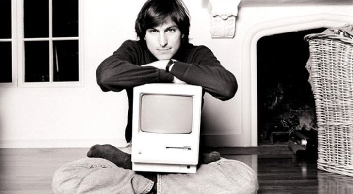 Steve Jobs with an Apple computer on his lap